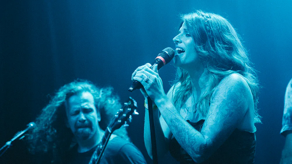 Vocalist and crowd under magenta stage lights at Louisville Loves Grunge